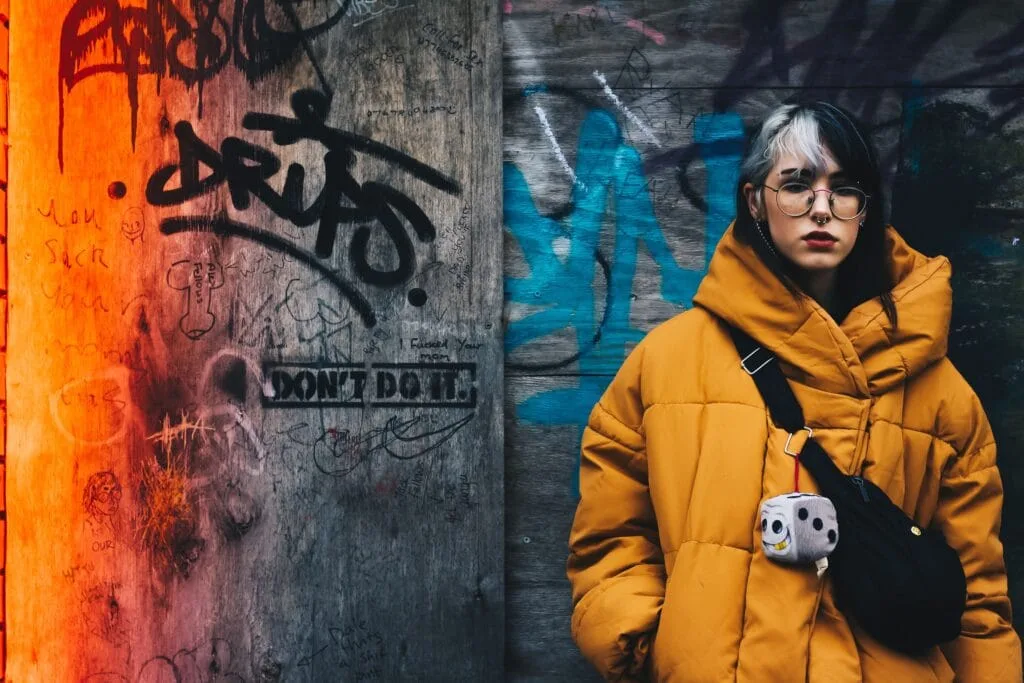 A LADY IS STANDING IN A STREET