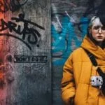 A LADY IS STANDING IN A STREET